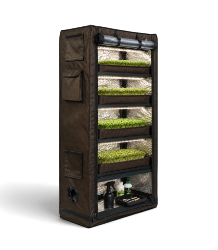 Multi-tier grow tent with lush green plants for indoor gardening.